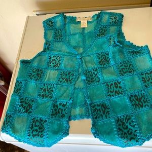 Got some blue suede shoes? I do but this post is a turquoise/black crochet vest.